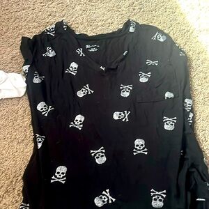 Black tank top with silver skulls.